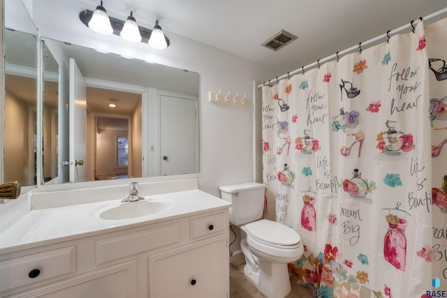 bathroom featuring tile patterned floors, vanity, toilet, and walk in shower