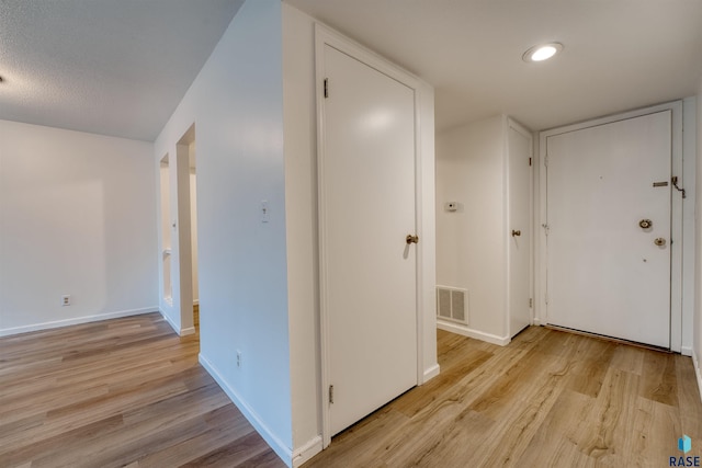 corridor featuring light hardwood / wood-style floors