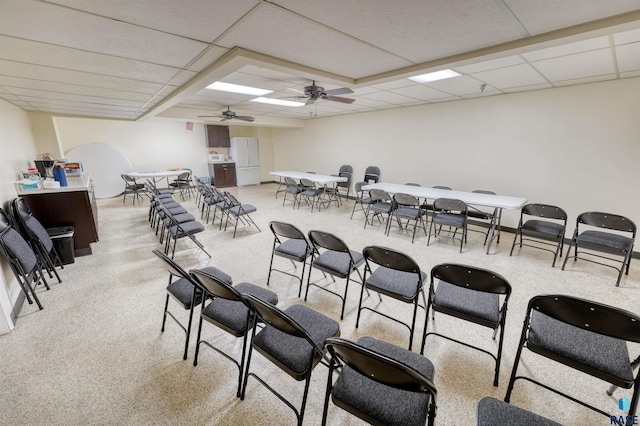 interior space featuring a drop ceiling and ceiling fan