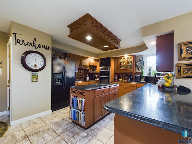 kitchen featuring backsplash, premium range hood, black fridge with ice dispenser, stainless steel double oven, and a kitchen island