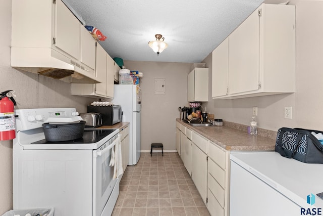 kitchen featuring a textured ceiling, sink, white cabinets, and white appliances