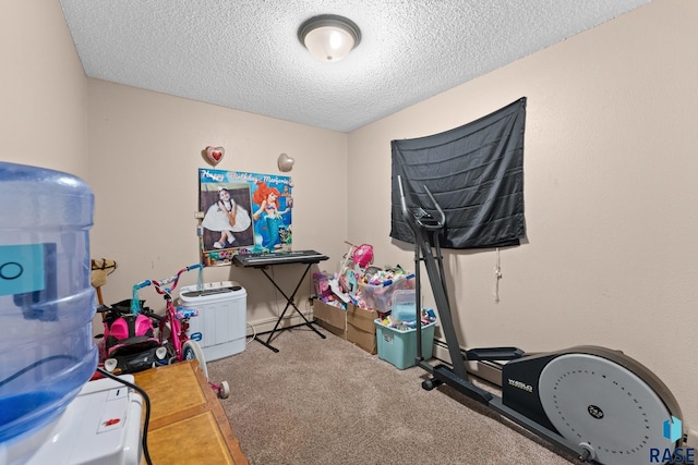 exercise area with carpet and a textured ceiling