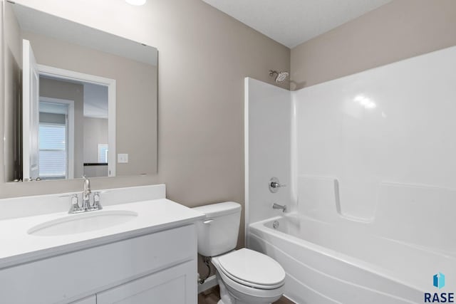 full bathroom with vanity, washtub / shower combination, a textured ceiling, and toilet