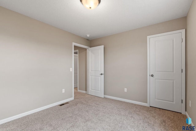 unfurnished bedroom featuring light carpet