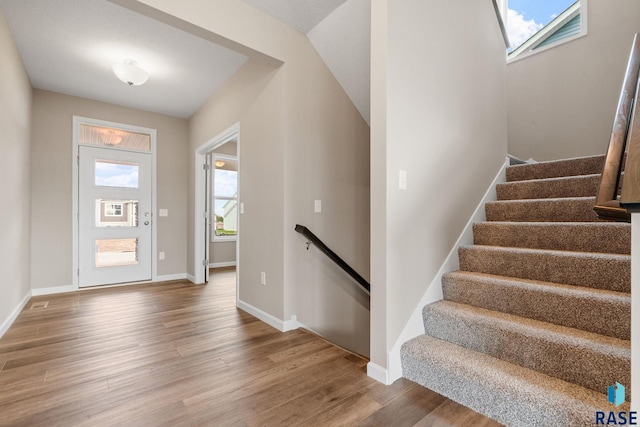 entrance foyer featuring hardwood / wood-style floors and lofted ceiling