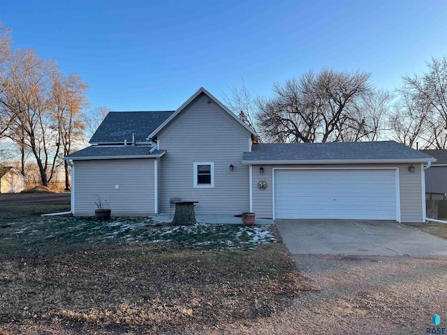 rear view of property featuring a garage