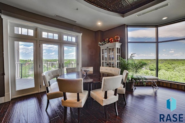 dining area with dark hardwood / wood-style flooring and french doors