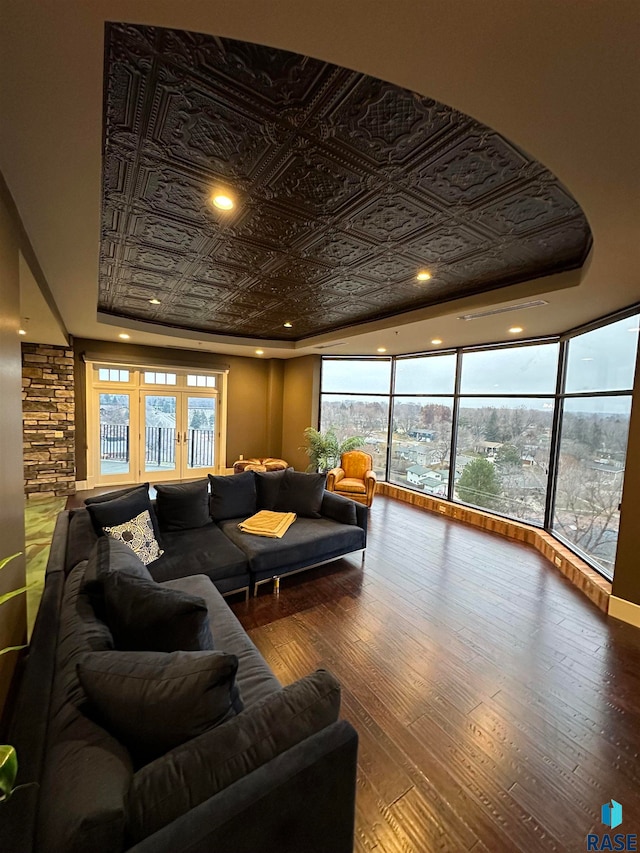 living room featuring hardwood / wood-style floors and a raised ceiling