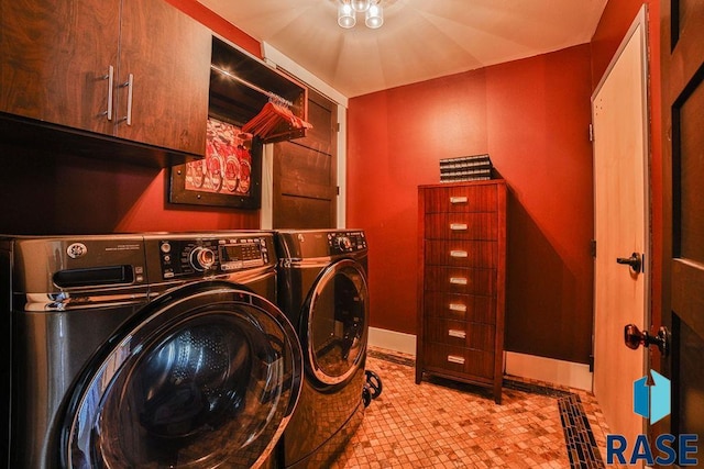 laundry room featuring cabinets and separate washer and dryer