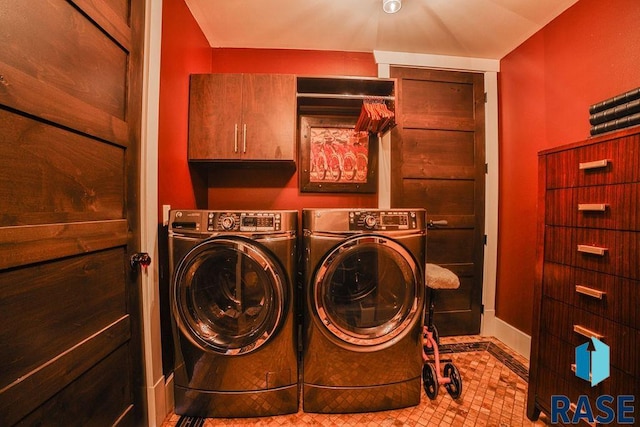 washroom with light tile patterned flooring, cabinets, and independent washer and dryer