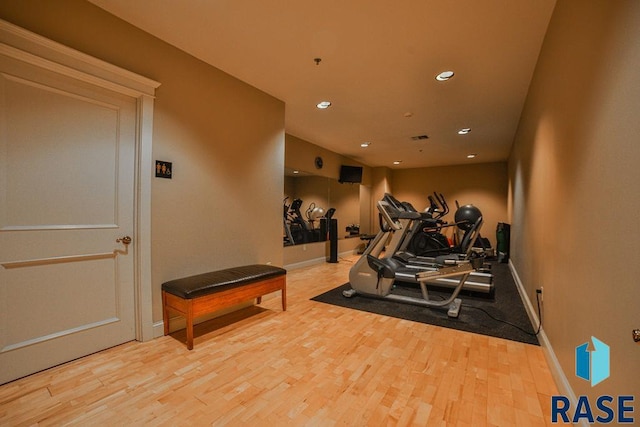 workout room featuring light hardwood / wood-style flooring