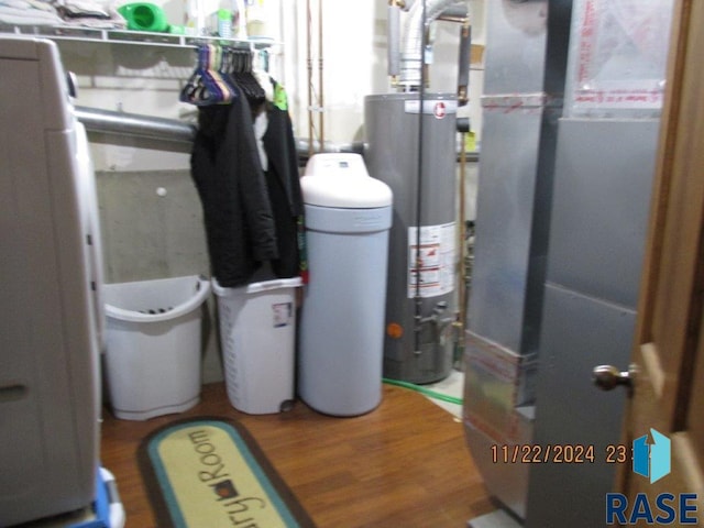 utility room with gas water heater and heating unit