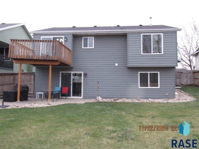 rear view of house with a patio area and a yard