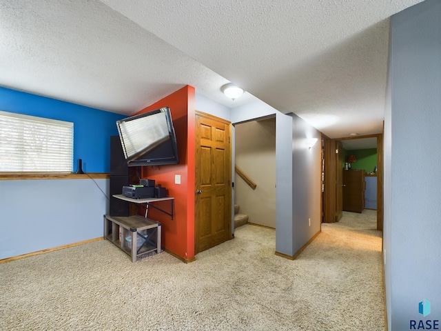 living room with a textured ceiling and light colored carpet