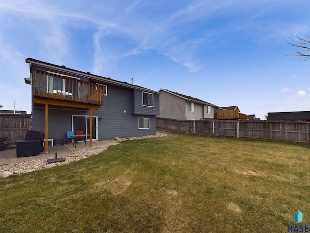 rear view of house with a yard and a patio