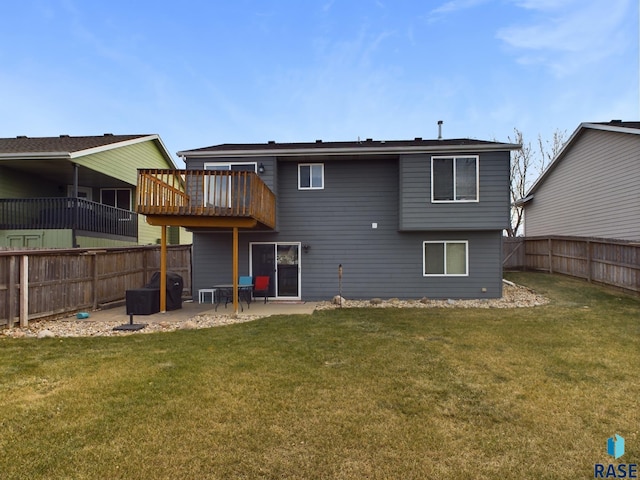 rear view of property with a yard and a patio area