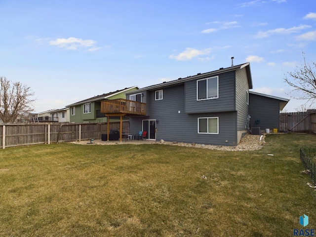 rear view of property with a lawn, a patio area, and central air condition unit