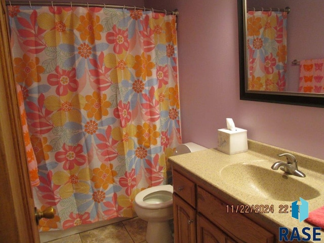 bathroom featuring tile patterned floors, curtained shower, vanity, and toilet