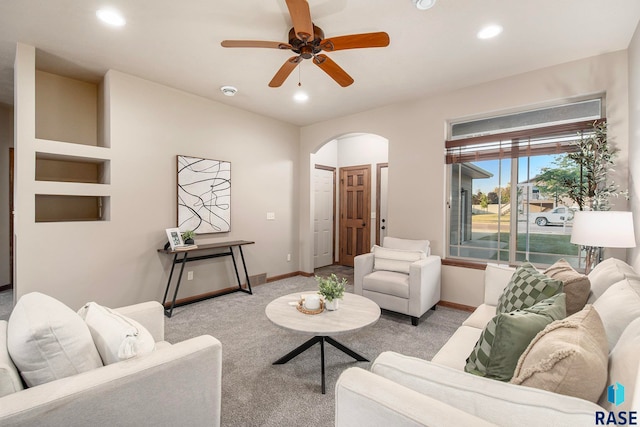 living room featuring ceiling fan and light colored carpet