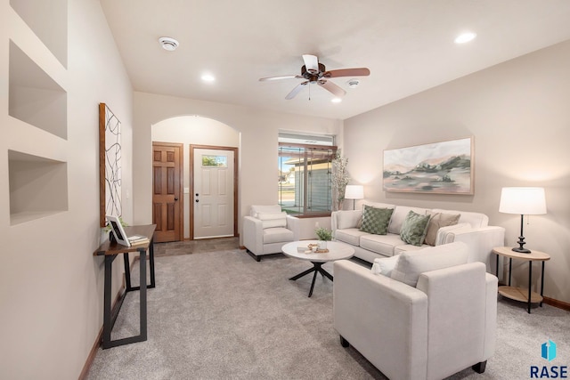 living room featuring light carpet and ceiling fan