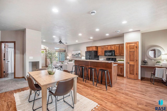 dining area featuring light wood-type flooring and ceiling fan