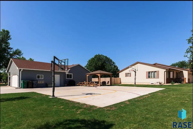 view of sport court featuring a gazebo and a lawn