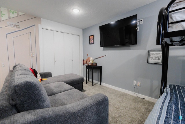 carpeted living room featuring a textured ceiling