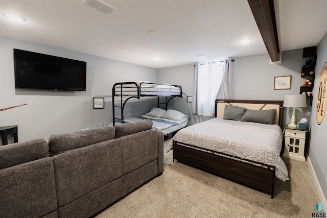 bedroom featuring beamed ceiling and light colored carpet