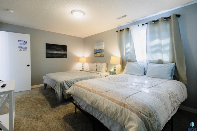 carpeted bedroom with a textured ceiling