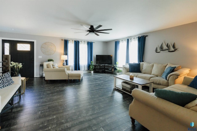 living room featuring dark hardwood / wood-style flooring and ceiling fan