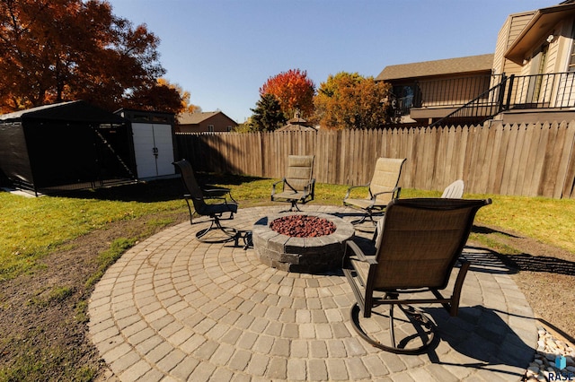 view of patio with a fire pit and a storage unit