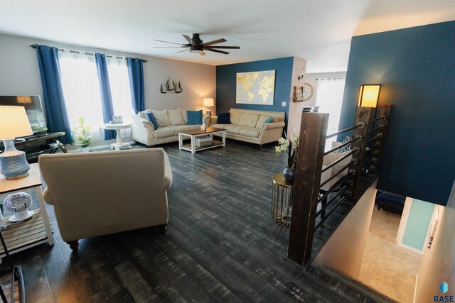 living room featuring ceiling fan and dark hardwood / wood-style floors