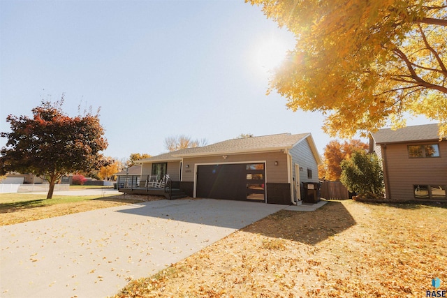 view of front of home with a garage and a wooden deck