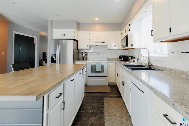 kitchen with sink, white cabinets, dark wood-type flooring, and white appliances