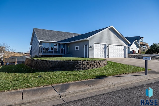 ranch-style house featuring a garage and a front lawn