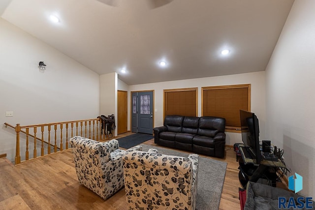 living room featuring hardwood / wood-style flooring and vaulted ceiling