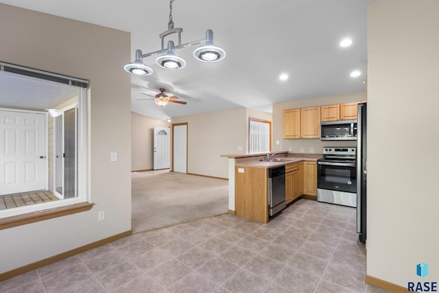 kitchen featuring kitchen peninsula, appliances with stainless steel finishes, light brown cabinetry, ceiling fan, and hanging light fixtures