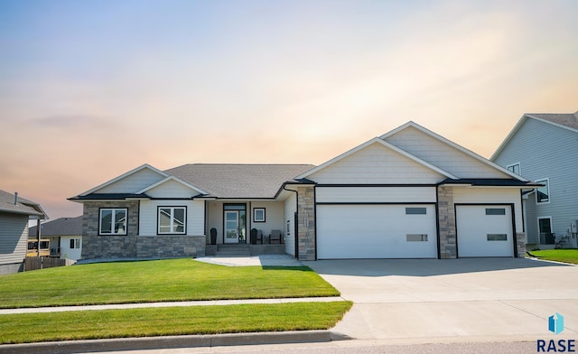 view of front of property featuring a yard and a garage