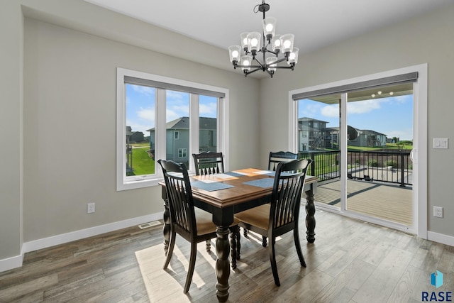 2704 S Snow Mass Ave, Sioux Falls, SD 57110 - dining area with a chandelier, baseboards, and wood finished floors