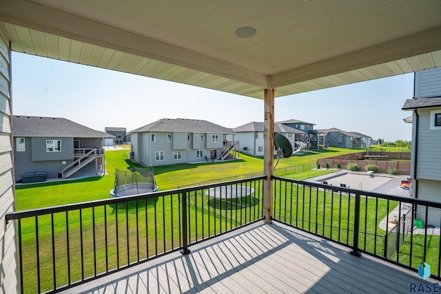 2704 S Snow Mass Ave, Sioux Falls, SD 57110 - wooden terrace with a residential view, a trampoline, and a lawn