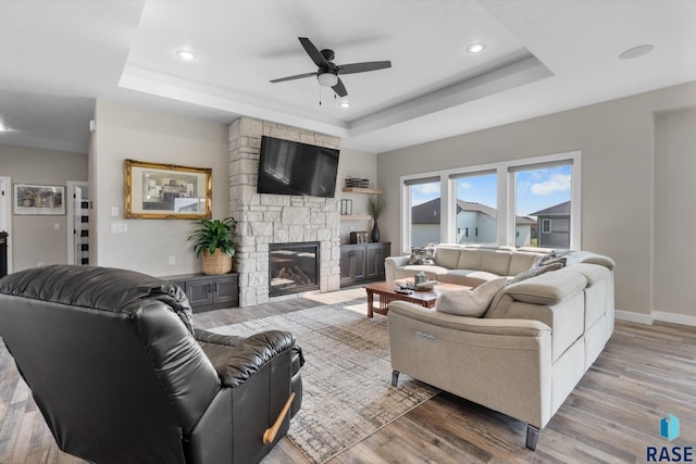 2704 S Snow Mass Ave, Sioux Falls, SD 57110 - living room with a raised ceiling, a ceiling fan, wood finished floors, recessed lighting, and a fireplace