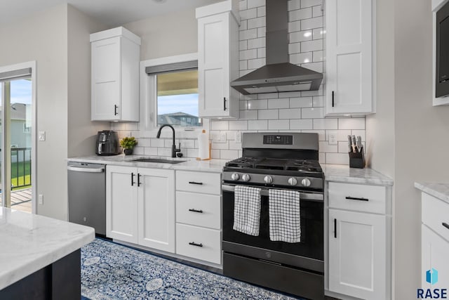 2704 S Snow Mass Ave, Sioux Falls, SD 57110 - kitchen with stainless steel appliances, wall chimney exhaust hood, a sink, tasteful backsplash, and white cabinetry