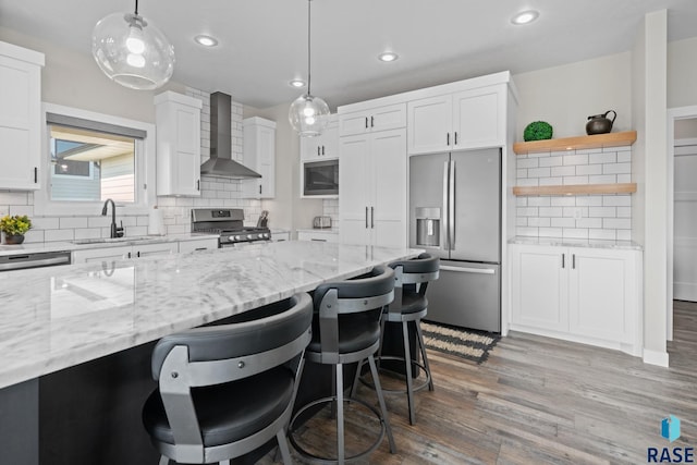 2704 S Snow Mass Ave, Sioux Falls, SD 57110 - kitchen with wall chimney exhaust hood, stainless steel appliances, white cabinets, tasteful backsplash, and a sink