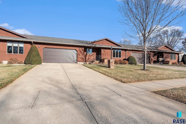 single story home with a garage and a front lawn