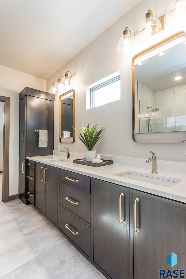 bathroom featuring a tile shower and vanity