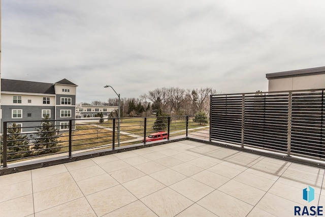 view of patio featuring a balcony