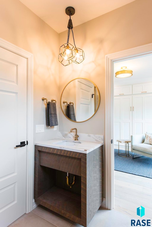 bathroom featuring a chandelier, vanity, and wood-type flooring