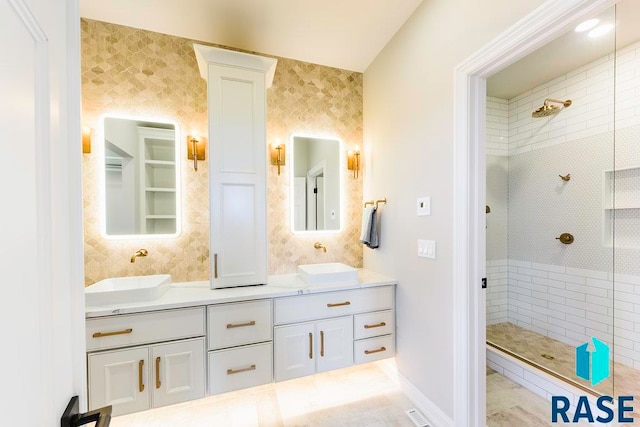 bathroom featuring vanity and tiled shower