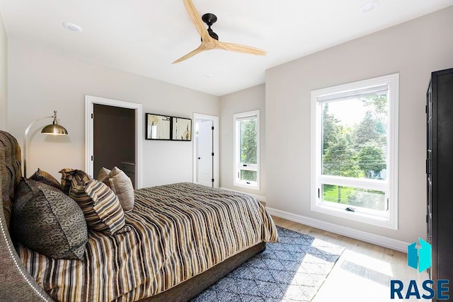 bedroom with ceiling fan and light hardwood / wood-style floors