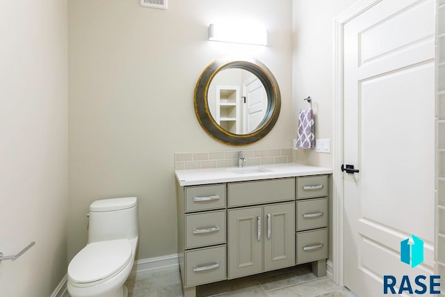 bathroom with tile patterned floors, vanity, and toilet